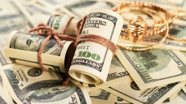 rolls of cash and jewelry